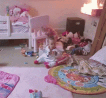 a child 's bedroom with a lot of toys on the floor and a bed