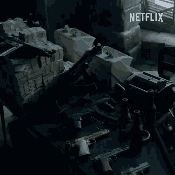 a bunch of guns are on a table with a netflix logo in the background