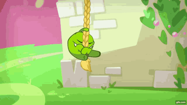 a green cartoon character is hanging from a rope with a brick wall in the background