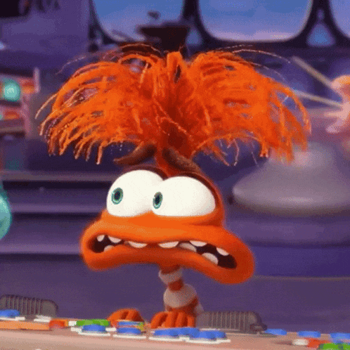 a cartoon character with orange hair is sitting on a table