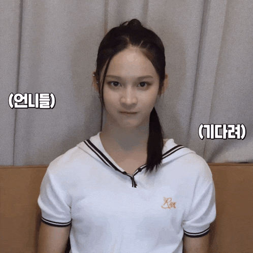 a girl wearing a white shirt with the letter x on the front