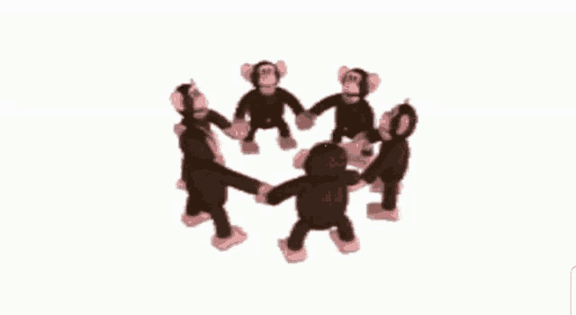 a group of stuffed monkeys are dancing in a circle holding hands .