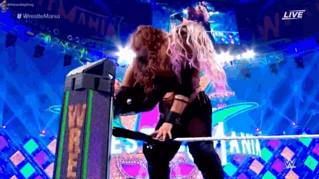 a woman is standing on a stage in front of a screen that says live