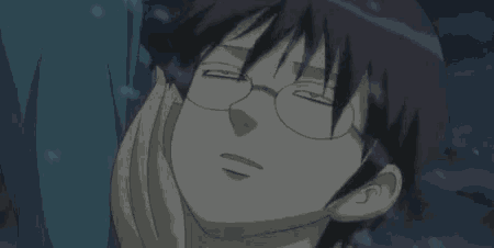 a close up of a person wearing glasses with their eyes closed and smiling .