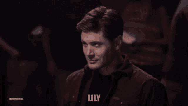 a man wearing a red shirt with the word lily written on it