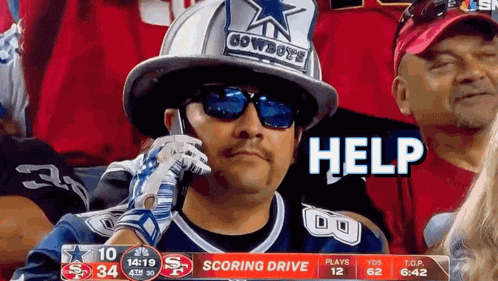 a man wearing a cowboys hat is talking on his cell phone
