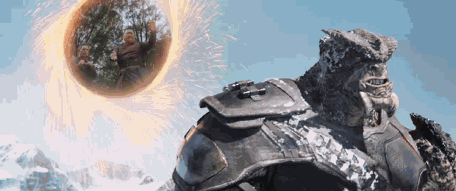 a statue of a man is standing in front of a sphere of fire