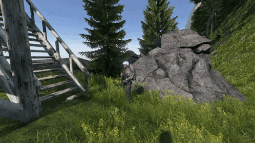 a man in a helmet is standing in a grassy field next to a staircase
