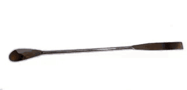 four metal spatulas are sitting on a wooden table