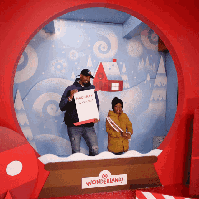 a man holds a sign that says naughty in front of a wonderland sign