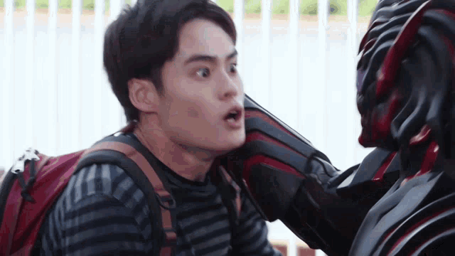a man with a backpack is talking to a monster