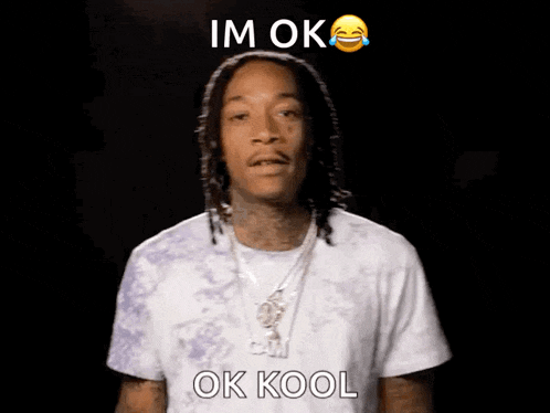 a man in a white shirt is making a funny face with the words im ok ok kool below him