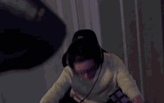 a man wearing headphones and glasses is sitting in front of a computer .
