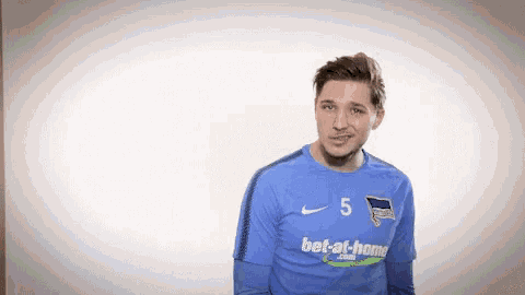 a man wearing a blue nike shirt with the number 5 on it