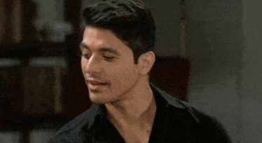a man and woman are looking at each other and smiling