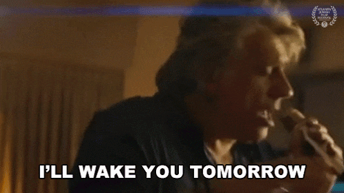 a woman is singing into a microphone and saying i 'll wake you tomorrow .