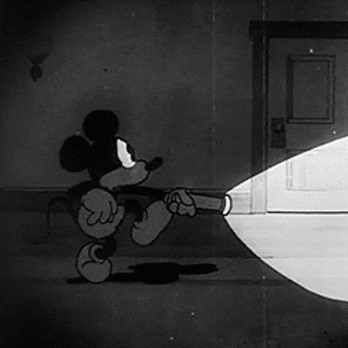a cartoon of mickey mouse holding a flashlight