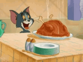 a cartoon of tom and jerry eating a turkey on a table