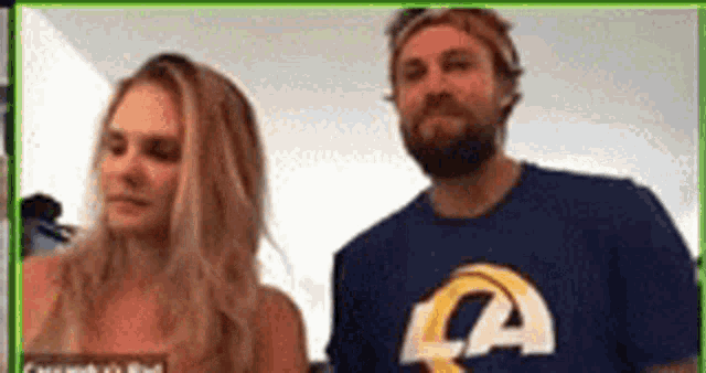 a man and a woman are standing next to each other .