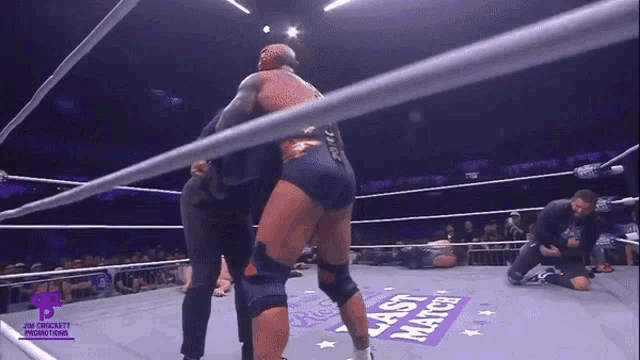 a wrestling ring with a purple sign that says last match on it