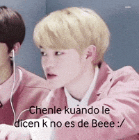 a man in a pink jacket is sitting next to another man wearing headphones and says chenle kuando le