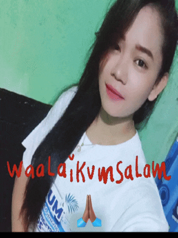 a woman taking a selfie with the words waalaikvmsalam written in red