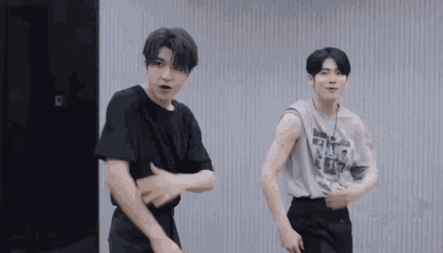 two men are dancing together in a room .