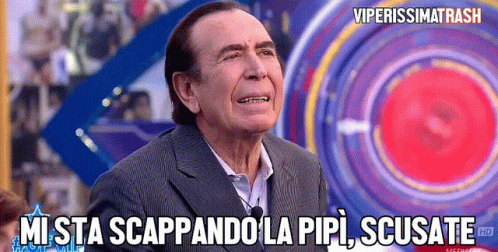 a man in a suit says " mi sta scappando la pipi scusate " in front of a colorful background