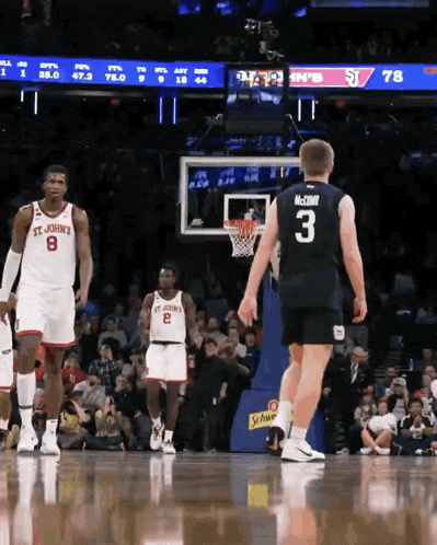 a basketball player with the number 3 on his jersey stands on the court