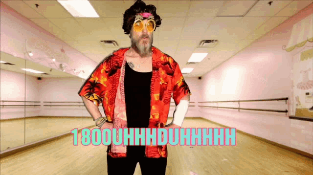a man in a hawaiian shirt is standing in a dance studio with the words 1800uhhhduhhhh written on the floor