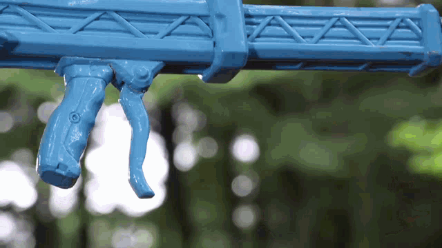 a blue toy gun with a green background