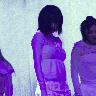 a woman in a white dress is standing in front of a screen that says ' roxy ' on it