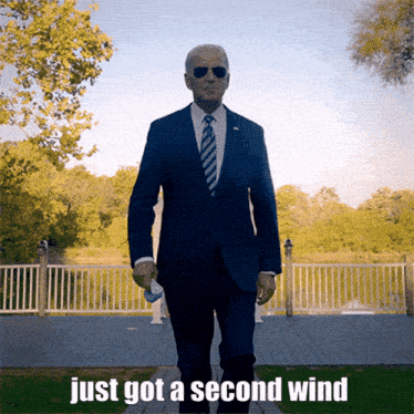 a man in a suit and tie walking with the words just got a second wind