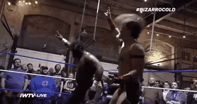 two wrestlers in a ring with the words #bizarrocold on the top