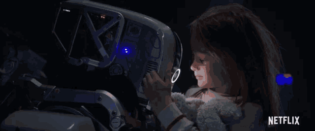 a little girl is looking at a robot with a netflix logo in the corner