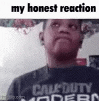 a man wearing a call of duty modern warfare t-shirt is making a funny face .
