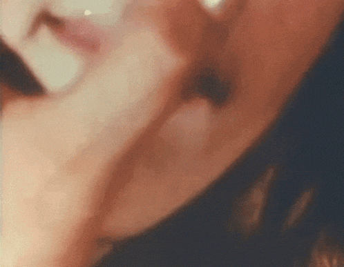 a close up of a woman 's face with a blurred background