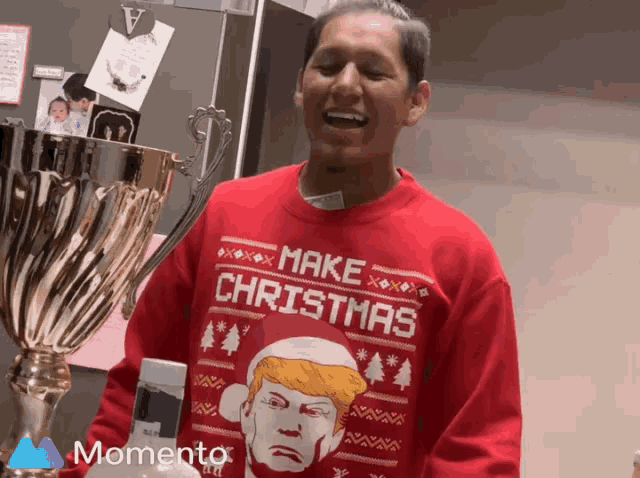 a man wearing a red sweater that says make christmas on it