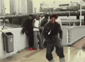 a man is dancing in front of a sign that says www.adofficecentral.fr.