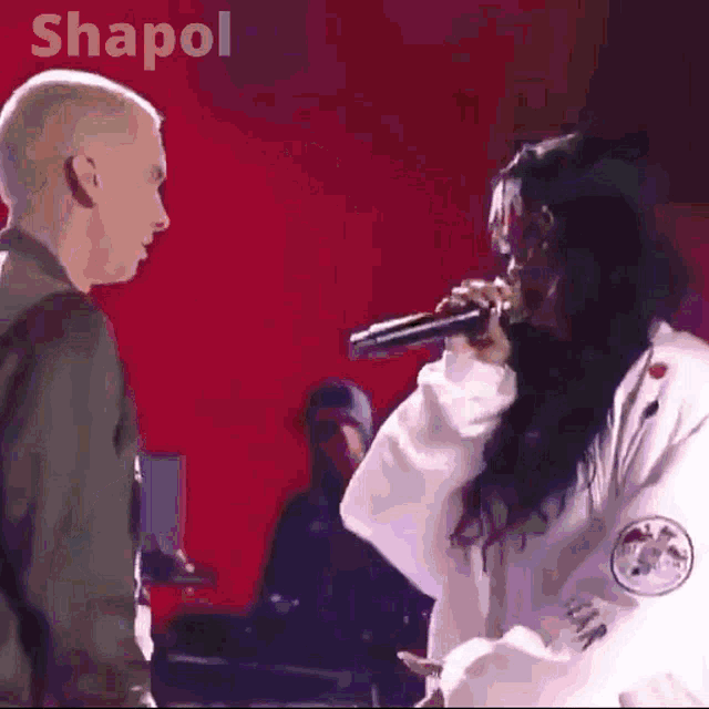 a man and a woman standing next to each other with the word shapol on the bottom right
