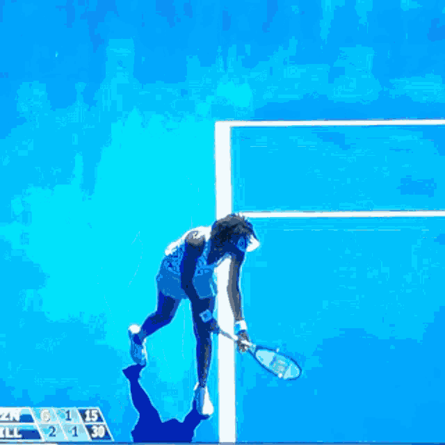 a tennis game is being played on a blue court with a banner that says ase