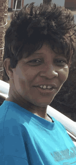 a woman wearing a blue t-shirt that says nike on the front