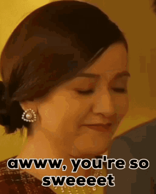 a close up of a woman 's face with the words " awww , you 're so sweet " written on it