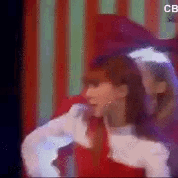 a blurred image of a woman with the letters cb on the bottom right