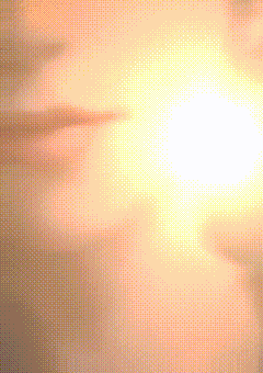a close up of a person 's face with the sun in the background