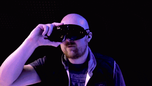 a man wearing a pair of goggles is making a funny face .