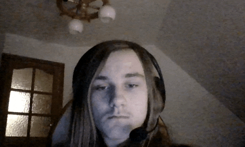 a man with long hair is wearing headphones and a microphone