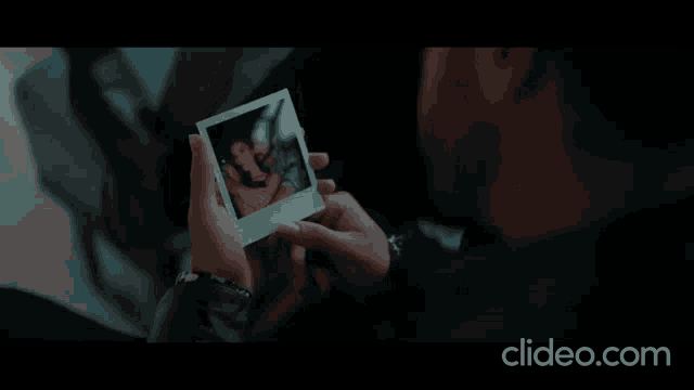a man is taking a picture of himself with a cell phone .