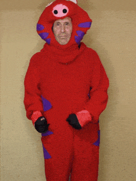 a man is wearing a red costume with a pig head