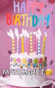 a birthday cake with candles on it and the name margaret written on it .